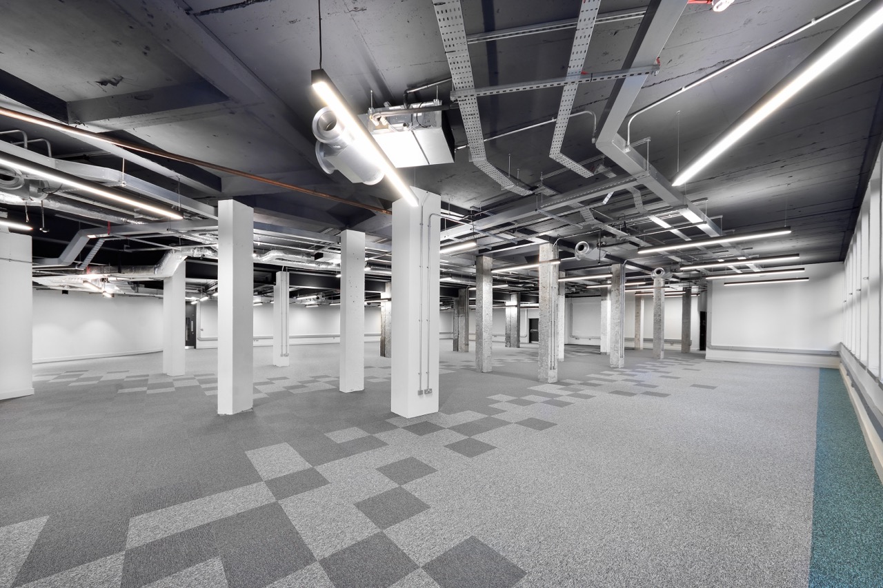 Open-plan office space in Edinburgh with grey patterned carpet tiles