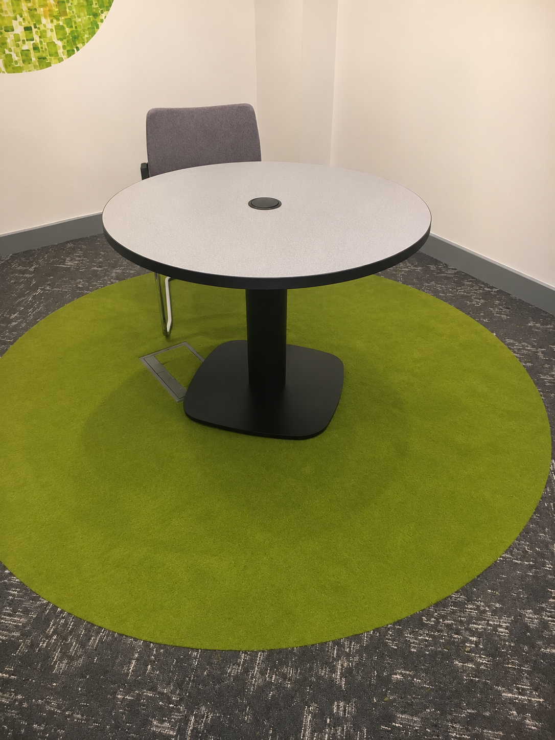 Carpet office 1 Office meeting room with grey carpet tiles and a circular green carpet inset
