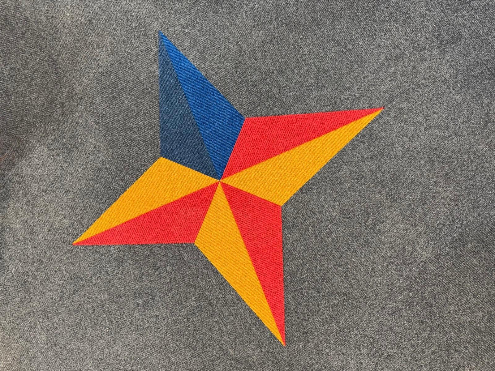 Carpet tiles bespoke design education Bespoke star design inset into grey carpet tiles in a school