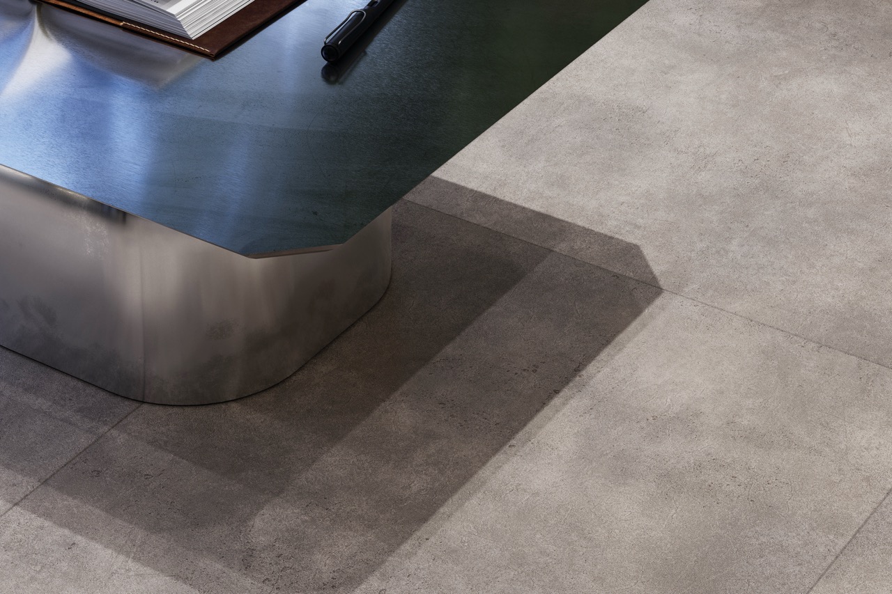 Grey stone-effect hotel flooring around a curved reception desk