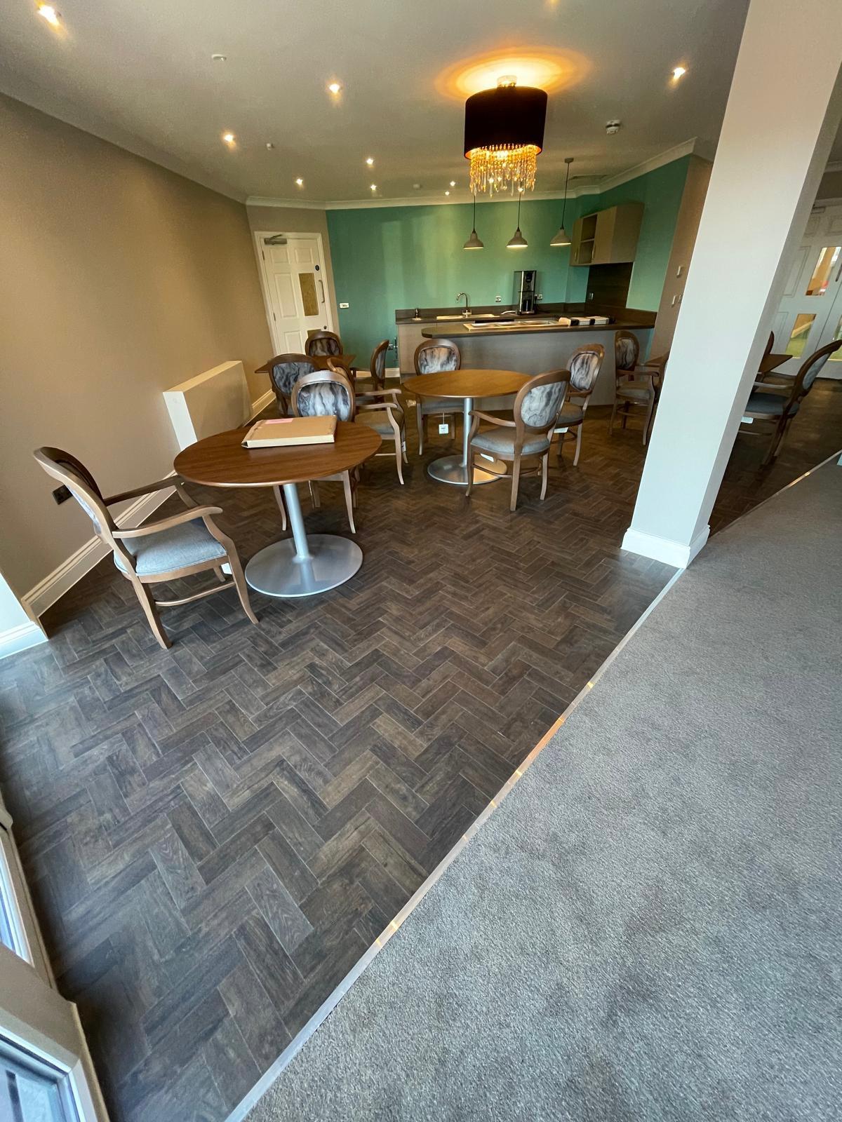 Retirement village lounge with herringbone LVT and carpet