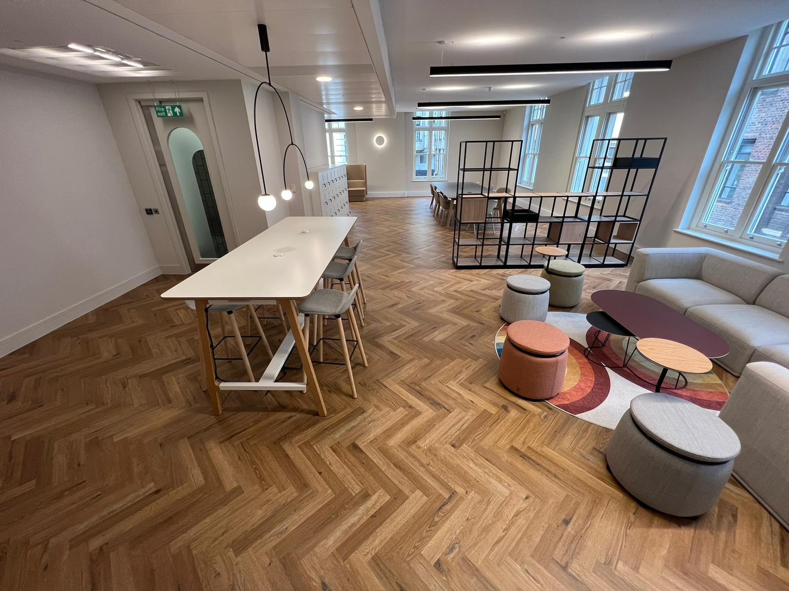 NT5 Office breakout area with herringbone wood-effect flooring and lounge seating